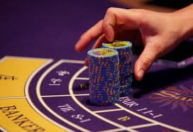 Live dealer at a blackjack table in a professional studio